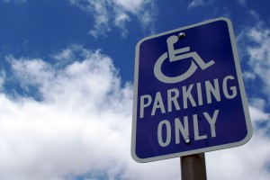 parking sign with wheelchair and the words parking only